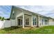 Rear view of home featuring a covered patio, white pillars, sliding glass doors, and several windows at 2598 Old Ashworth Nw Ln, Concord, NC 28027