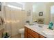 Bright bathroom features a shower-tub combo and a wood vanity with a white countertop at 2598 Old Ashworth Nw Ln, Concord, NC 28027