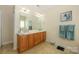 Bathroom featuring double vanity, large mirror, tile floor, and neutral walls at 2598 Old Ashworth Nw Ln, Concord, NC 28027