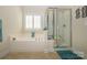 Bathroom featuring a garden tub, glass enclosed shower, and tile flooring at 2598 Old Ashworth Nw Ln, Concord, NC 28027
