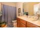 Bathroom featuring a light wood vanity with a large mirror and shower with blue curtain at 2598 Old Ashworth Nw Ln, Concord, NC 28027