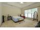 Bedroom features a ceiling fan, tray ceiling, and an abundance of natural light at 2598 Old Ashworth Nw Ln, Concord, NC 28027