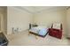 Bedroom with neutral walls and carpet features a bench seat and a red armchair at 2598 Old Ashworth Nw Ln, Concord, NC 28027