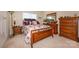 Bedroom with a wooden bed frame, matching nightstands, and a dresser set at 2598 Old Ashworth Nw Ln, Concord, NC 28027