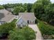 Home with manicured lawn, shrubbery, two-car garage, and gray accented shutters on front windows at 2598 Old Ashworth Nw Ln, Concord, NC 28027