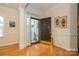 The foyer offers hardwood floors, intricate trim, and a warm welcome with abundant natural light from decorative windows at 2598 Old Ashworth Nw Ln, Concord, NC 28027