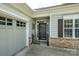 Inviting entrance features a decorative security gate, brick accents, and adjacent garage access for added convenience and curb appeal at 2598 Old Ashworth Nw Ln, Concord, NC 28027