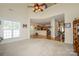 Open living room with large window, hardwood floors and view to kitchen at 2598 Old Ashworth Nw Ln, Concord, NC 28027