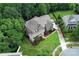 Aerial view of a two-story brick home with lush landscaping, mature trees, and well-maintained yard at 2652 Bedford Nw Pl, Concord, NC 28027