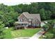 Aerial view of a charming brick house with a well-manicured lawn and mature trees at 2652 Bedford Nw Pl, Concord, NC 28027