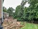 Beautiful backyard with mature trees, stone steps, and a multi-level deck and patio at 2652 Bedford Nw Pl, Concord, NC 28027