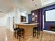 The basement bar has seating and mirrors and is adjacent to a theater room at 2652 Bedford Nw Pl, Concord, NC 28027