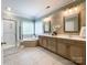 A bathroom features a double vanity, glass shower, soaking tub, mosaic backsplash, and tile floors at 2652 Bedford Nw Pl, Concord, NC 28027