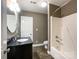 Neutral bathroom with black vanity, shower and tub combination, and tile flooring at 2652 Bedford Nw Pl, Concord, NC 28027