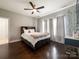 Large bedroom with hardwood floors, a ceiling fan, and natural light from windows at 2652 Bedford Nw Pl, Concord, NC 28027