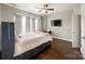 Spacious bedroom featuring hardwood floors, a ceiling fan, and natural light from windows at 2652 Bedford Nw Pl, Concord, NC 28027