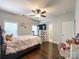 Bright bedroom featuring hardwood floors, a ceiling fan, and natural light from windows at 2652 Bedford Nw Pl, Concord, NC 28027