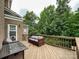 Spacious wooden deck with outdoor furniture, offering great views of the wooded backyard at 2652 Bedford Nw Pl, Concord, NC 28027