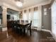 Well-lit dining room featuring a modern chandelier, hardwood floors, and large windows with bright natural light at 2652 Bedford Nw Pl, Concord, NC 28027