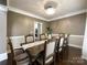 Elegant dining room with chandelier, hardwood floors, and neutral paint at 2652 Bedford Nw Pl, Concord, NC 28027