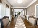 Spacious dining room featuring hardwood floors, large table, and classic decor at 2652 Bedford Nw Pl, Concord, NC 28027