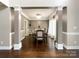 Formal dining room with elegant wainscoting, hardwood floors, and modern light fixture at 2652 Bedford Nw Pl, Concord, NC 28027