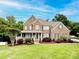 Charming brick two-story home with a welcoming front porch and manicured lawn, creating an inviting curb appeal at 2652 Bedford Nw Pl, Concord, NC 28027