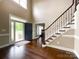 Welcoming foyer with high ceilings, hardwood floors, and staircase with metal spindles at 2652 Bedford Nw Pl, Concord, NC 28027