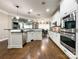 Bright kitchen featuring stainless steel appliances, white cabinets, and an open layout at 2652 Bedford Nw Pl, Concord, NC 28027