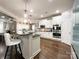 Modern kitchen with white cabinetry, stainless steel appliances, and a breakfast bar at 2652 Bedford Nw Pl, Concord, NC 28027