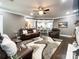 Open-concept living room with hardwood floors, comfortable leather seating, an airy atmosphere, and modern fan at 2652 Bedford Nw Pl, Concord, NC 28027