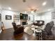 Inviting living room featuring a stone fireplace, large TV, comfortable leather seating, and hardwood floors at 2652 Bedford Nw Pl, Concord, NC 28027
