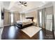 Spacious main bedroom with hardwood floors, a ceiling fan, and natural light from windows at 2652 Bedford Nw Pl, Concord, NC 28027