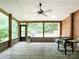 Relaxing screened porch with brick flooring and a ceiling fan, perfect for outdoor living at 2652 Bedford Nw Pl, Concord, NC 28027