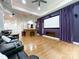 This theater room has an adjacent bar, leather seating, and hardwood floors at 2652 Bedford Nw Pl, Concord, NC 28027
