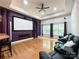 A theater room boasts a large screen, comfortable seating, hardwood floors, and purple accents at 2652 Bedford Nw Pl, Concord, NC 28027