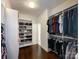 This walk-in closet offers built-in shelves and hanging rods for organized storage at 2652 Bedford Nw Pl, Concord, NC 28027