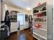 This walk-in closet features built-in shelves and drawers for ample storage at 2652 Bedford Nw Pl, Concord, NC 28027