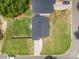 An aerial view of a house with a gray roof and a large green lawn surrounded by mature trees and a driveway at 3004 Marlowe Ave, Charlotte, NC 28208