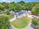 An aerial view of a charming two-story white home with a well-manicured lawn and lush trees in a tranquil neighborhood at 3004 Marlowe Ave, Charlotte, NC 28208