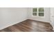 This bedroom features wood-look flooring, neutral walls, and natural light at 3004 Marlowe Ave, Charlotte, NC 28208