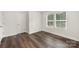 Bright bedroom features wood-look flooring, neutral walls, and windows for natural light at 3004 Marlowe Ave, Charlotte, NC 28208
