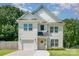 Charming two-story home with white siding, well-manicured lawn and attached garage at 3004 Marlowe Ave, Charlotte, NC 28208