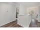 Upstairs hallway with hardwood floors and views into a bedroom at 3004 Marlowe Ave, Charlotte, NC 28208