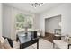 Well-lit home office featuring a desk, neutral tones, and views of the outdoors at 3004 Marlowe Ave, Charlotte, NC 28208
