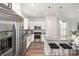 Modern kitchen with stainless steel appliances, granite countertops, and a breakfast bar at 3004 Marlowe Ave, Charlotte, NC 28208