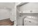 This laundry room features newer machines and overhead storage at 3004 Marlowe Ave, Charlotte, NC 28208