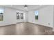 Sun-drenched bedroom with light wood floors, neutral walls, and multiple large windows at 416 Dalton Cir, Fort Mill, SC 29715