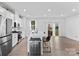 Bright open kitchen with stainless steel appliances, a large island, and access to the backyard at 416 Dalton Cir, Fort Mill, SC 29715
