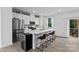 Modern kitchen features sleek white cabinets, stainless steel appliances, and a stylish center island with seating at 416 Dalton Cir, Fort Mill, SC 29715